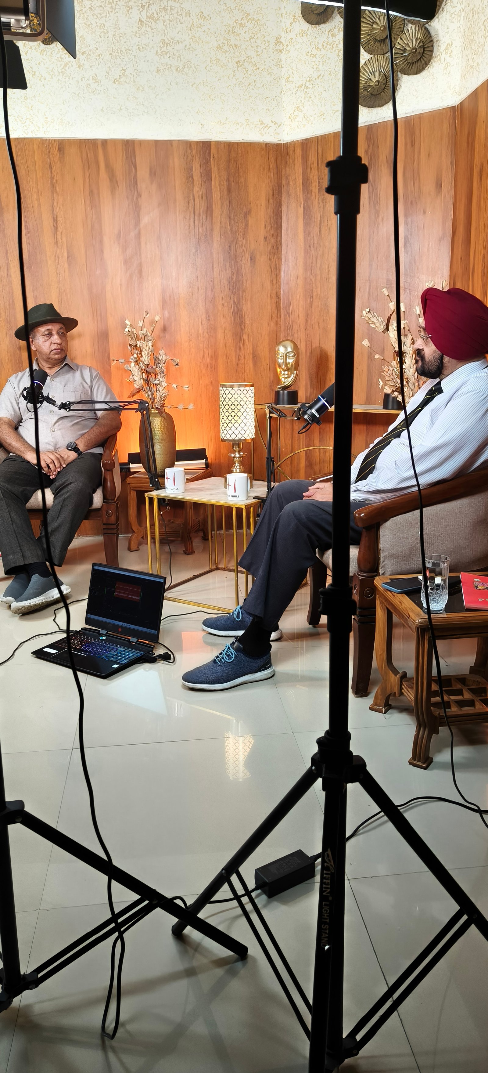 A HalfWall recording session with microphones, lights and guests in conversation